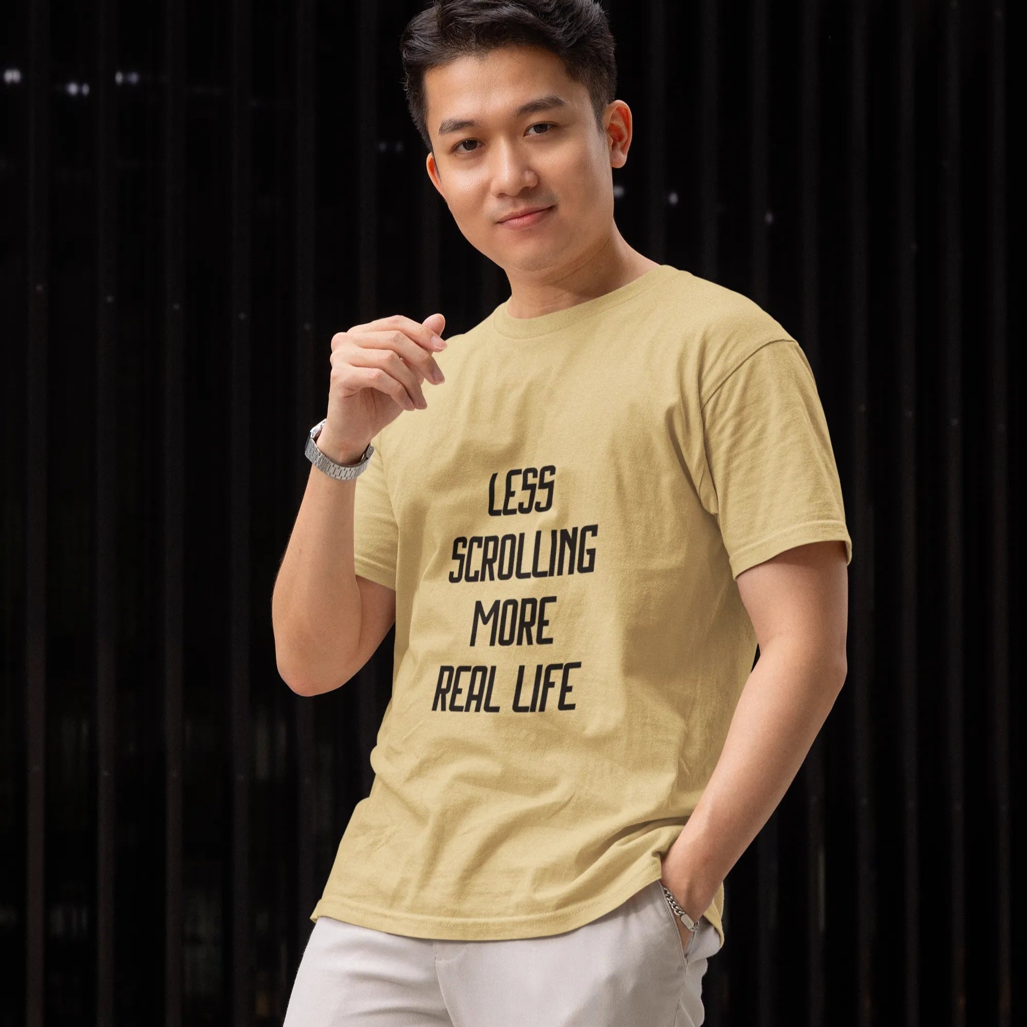 Person wearing a yellow t-shirt with text, standing against a dark background