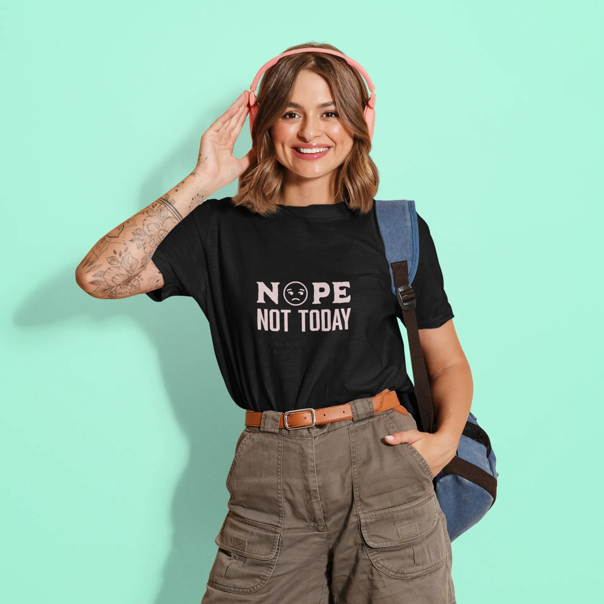 Person wearing a black t-shirt with 'NOPE NOT TODAY' text on a light green background
