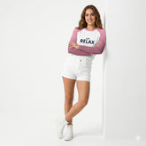 Woman wearing a pink and white shirt with 'JUST RELAX' text on a white background