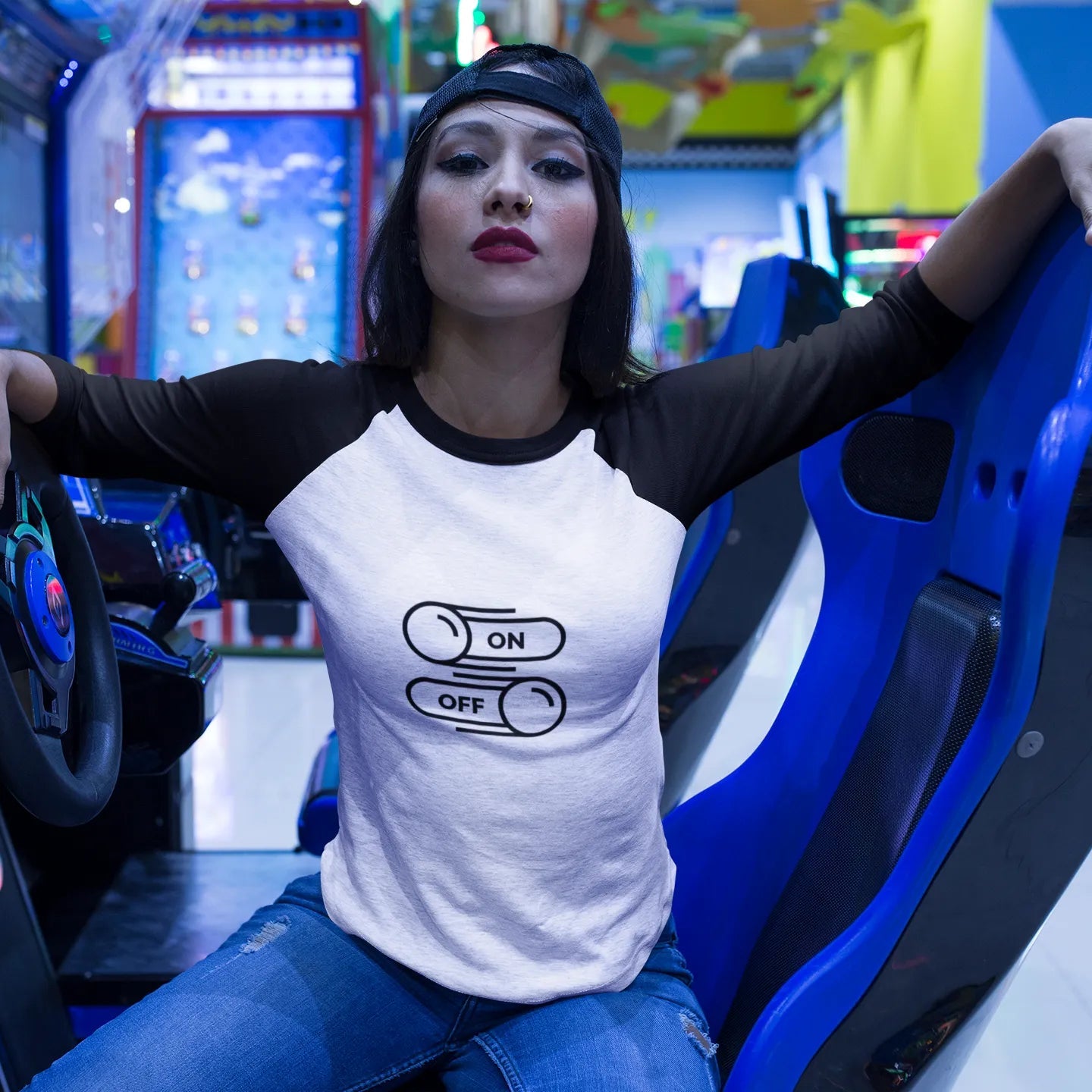 Woman sitting in a gaming chair with a gaming console in the background