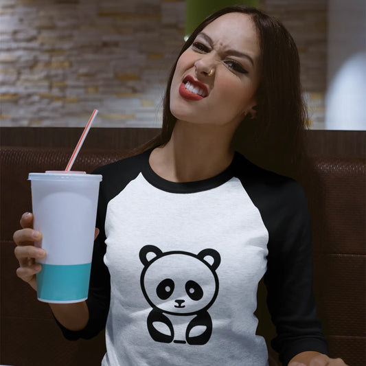 Woman wearing a panda t-shirt holding a drink in a casual setting