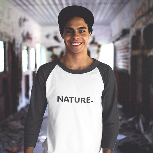 Person wearing a white and black baseball shirt with 'NATURE.' text in an indoor setting.