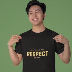 Person wearing a black t-shirt with 'KEEP CALM AND RESPECT OTHERS' text on a green background