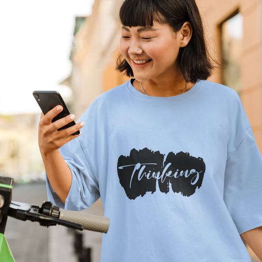 Woman using a smartphone on an electric scooter in an urban setting