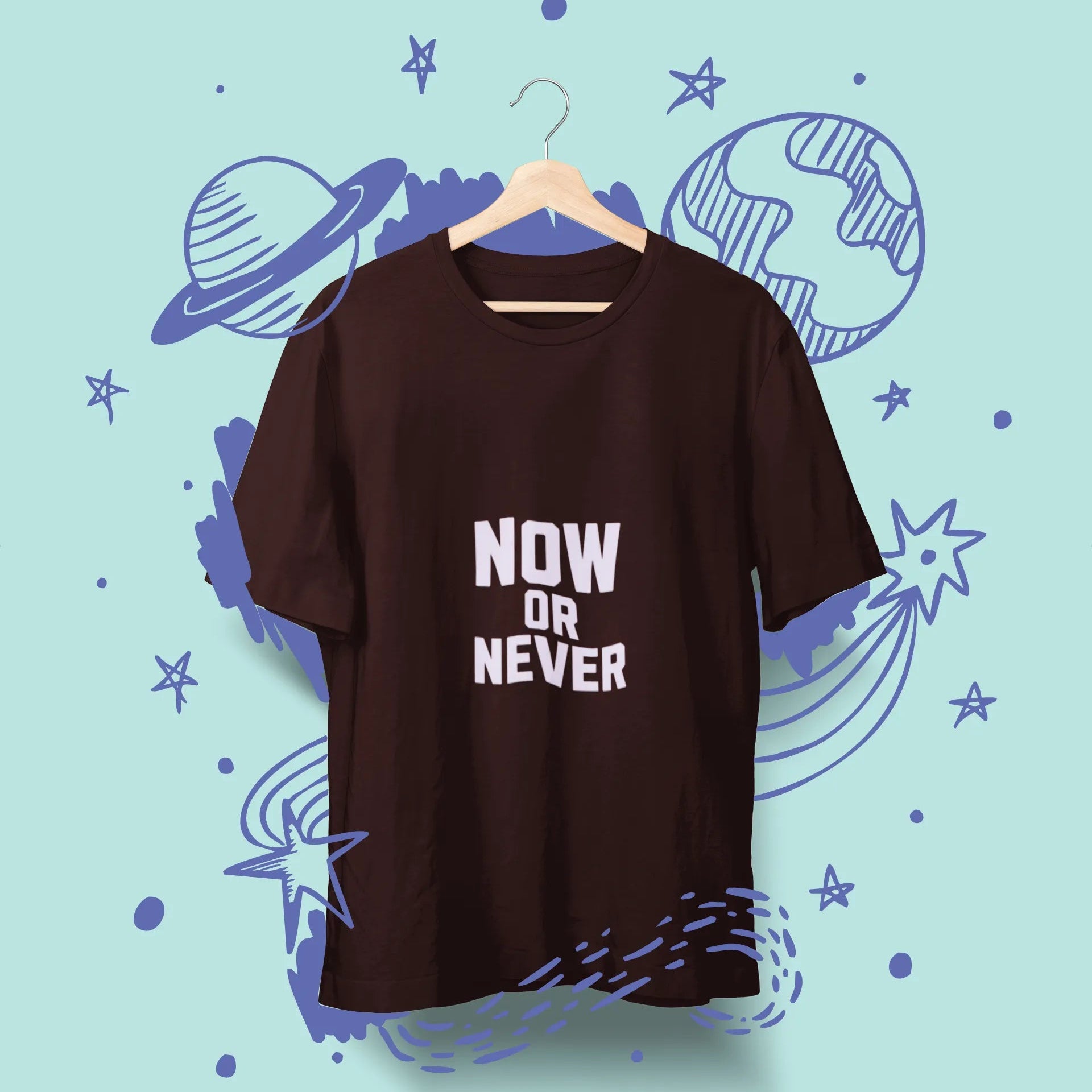 Brown t-shirt with 'NOW OR NEVER' text on a hanger against a space-themed background