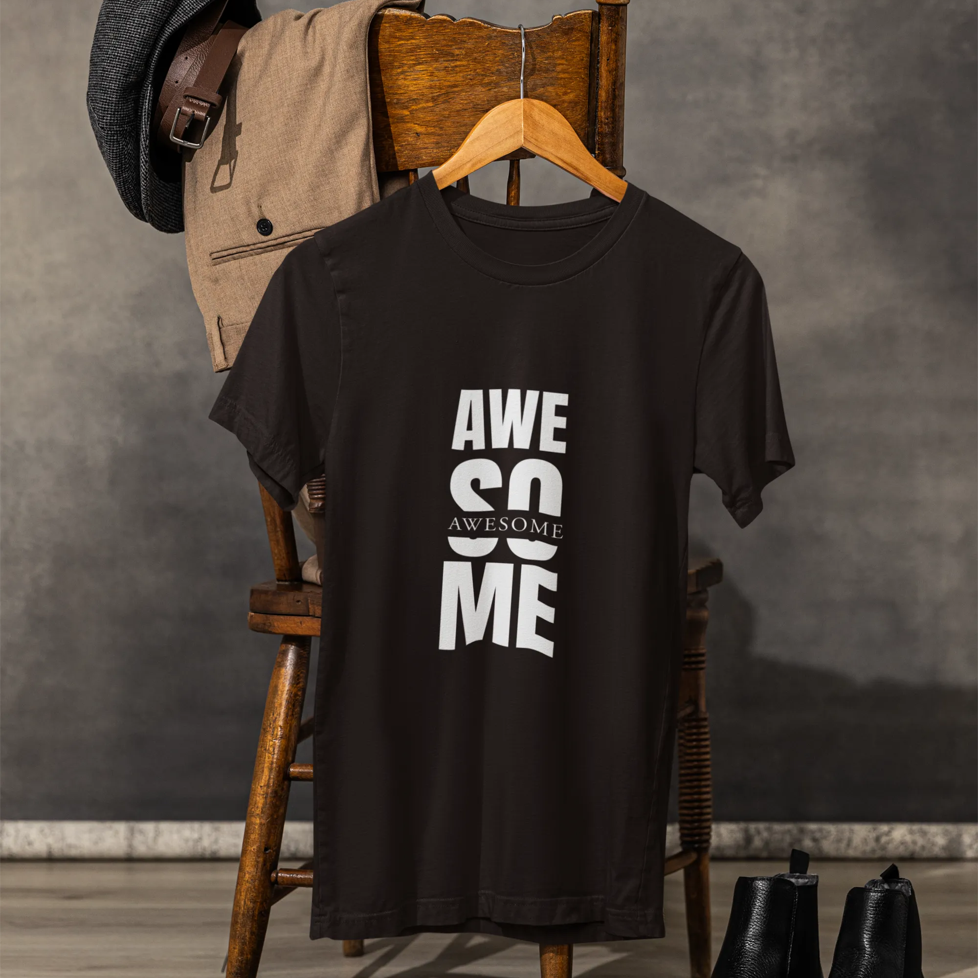 Black t-shirt with 'AWESOME' text on a wooden chair against a gray background