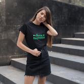 Woman wearing a black t-shirt with 'VEGAN HAPPINESS' text on steps.