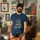 Man holding a guitar in a room with various decorations on the walls.