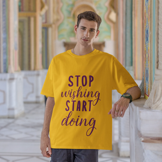 Man wearing a yellow t-shirt with motivational text in an ornate architectural setting
