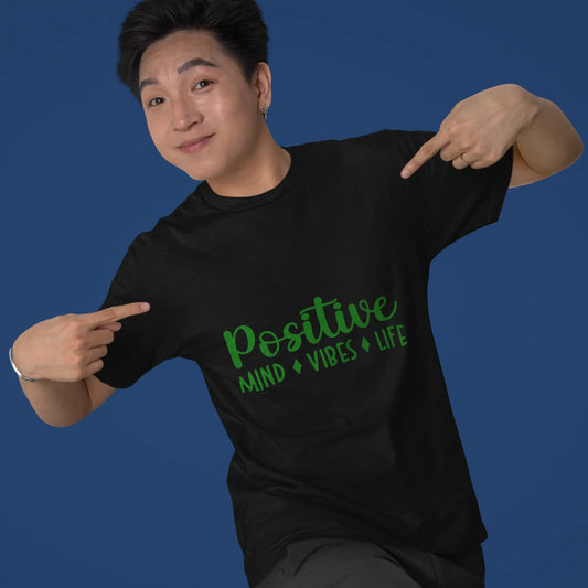 Person wearing a black t-shirt with 'Positive Mind Vibes Life' text on a blue background