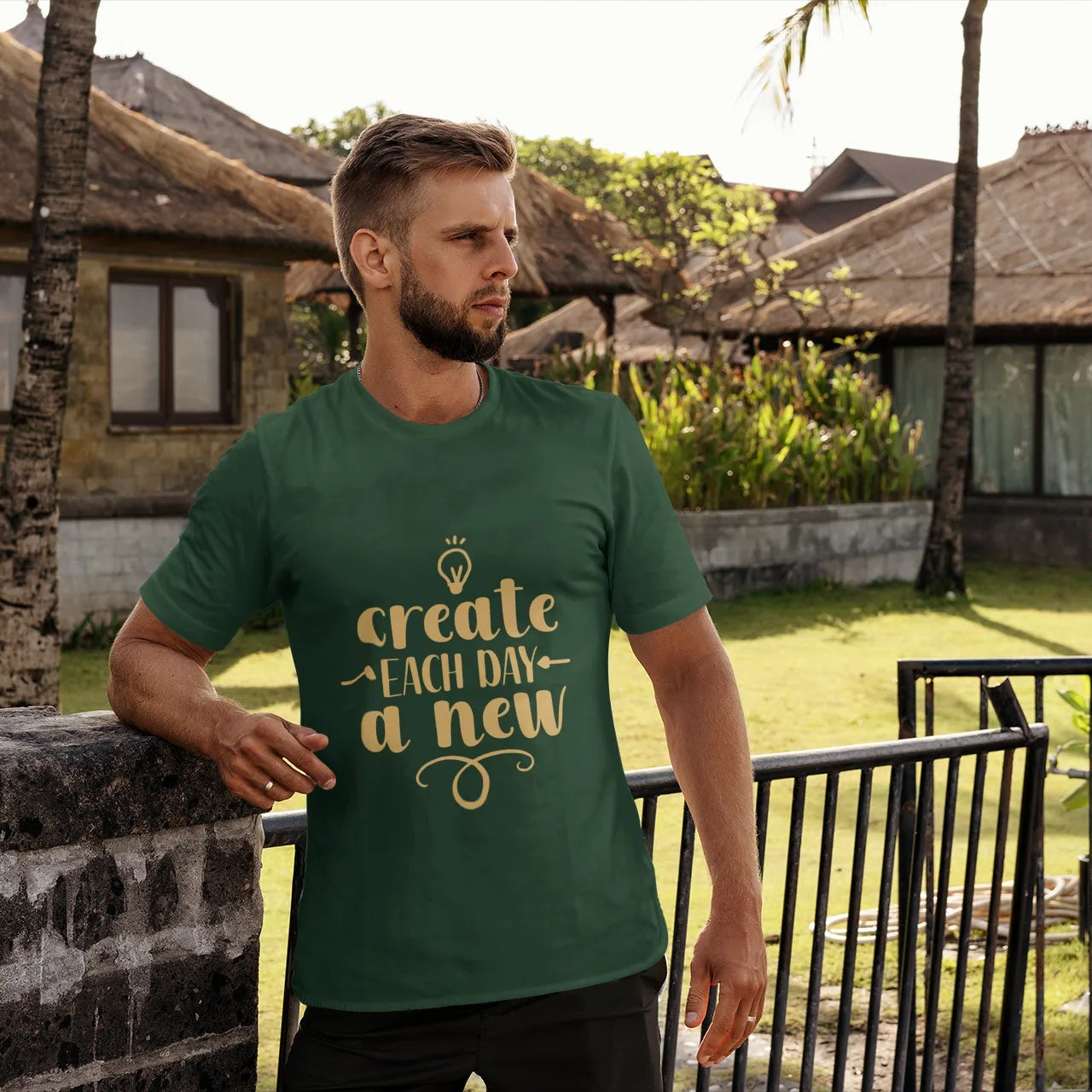 Man wearing a green t-shirt with a motivational quote in a tropical setting