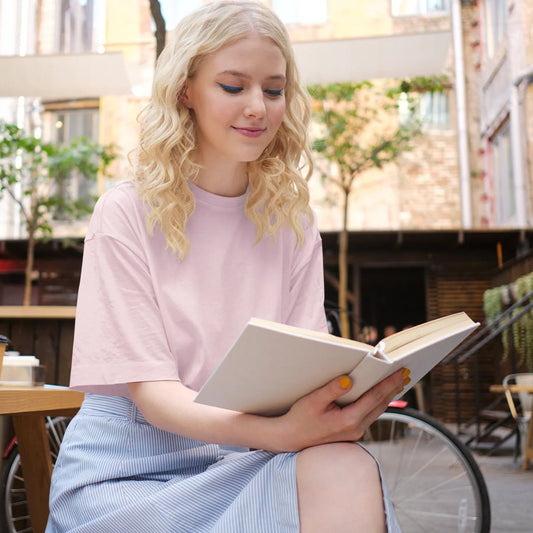Woman reading a book in an outdoor cafe setting
