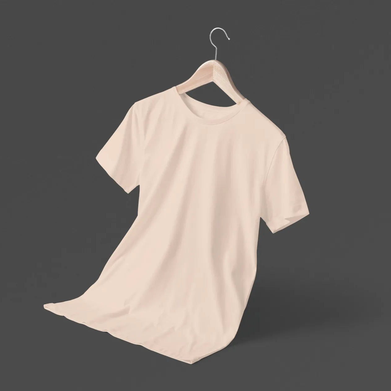 Beige t-shirt on a hanger against a dark background
