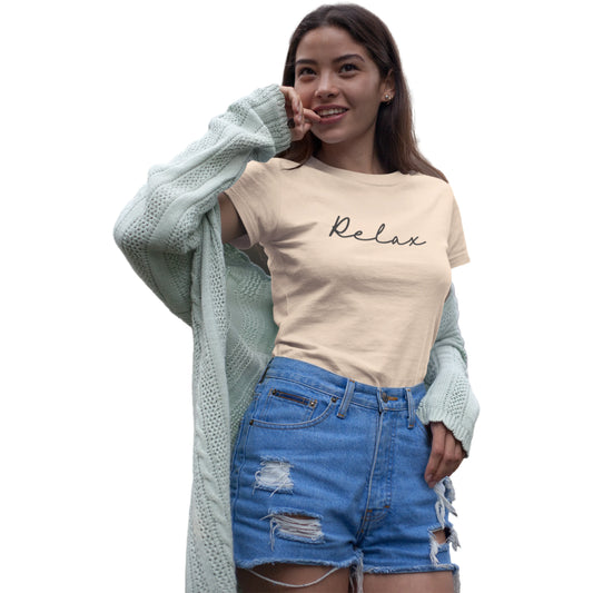 Woman wearing a beige 'Relax' t-shirt, blue shorts, and a light green cardigan on a white background