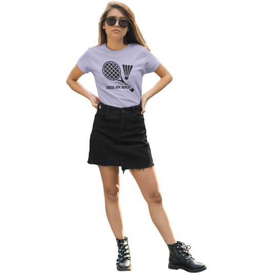 Woman wearing a light purple t-shirt with a graphic design and text, black denim skirt, and black boots on a white background.