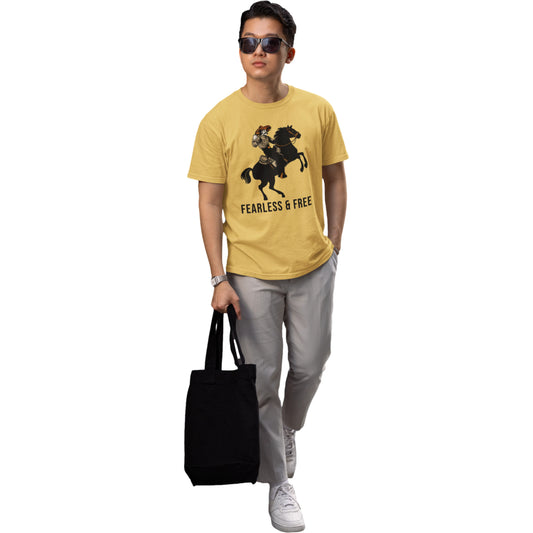 Person wearing a yellow t-shirt with a graphic design and text, holding a black tote bag on a white background