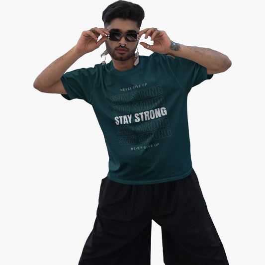 Man wearing a green t-shirt with motivational text on a white background