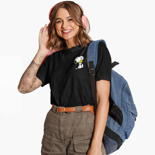 Person wearing a black t-shirt with a cartoon character, brown pants, and a blue backpack on a white background