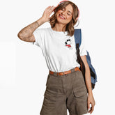Woman wearing a white t-shirt with a graphic design, brown cargo shorts, and a blue backpack on a white background