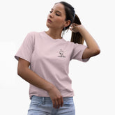 Woman wearing a light pink t-shirt with a small graphic on a white background