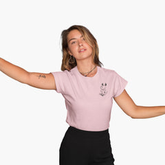 Person wearing a pink t-shirt with a small graphic design on a white background