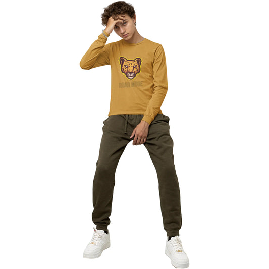 Person wearing a mustard yellow long-sleeve shirt with a bear graphic and green pants on a white background