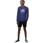 Man wearing a blue long-sleeve shirt with a graphic design on a white background
