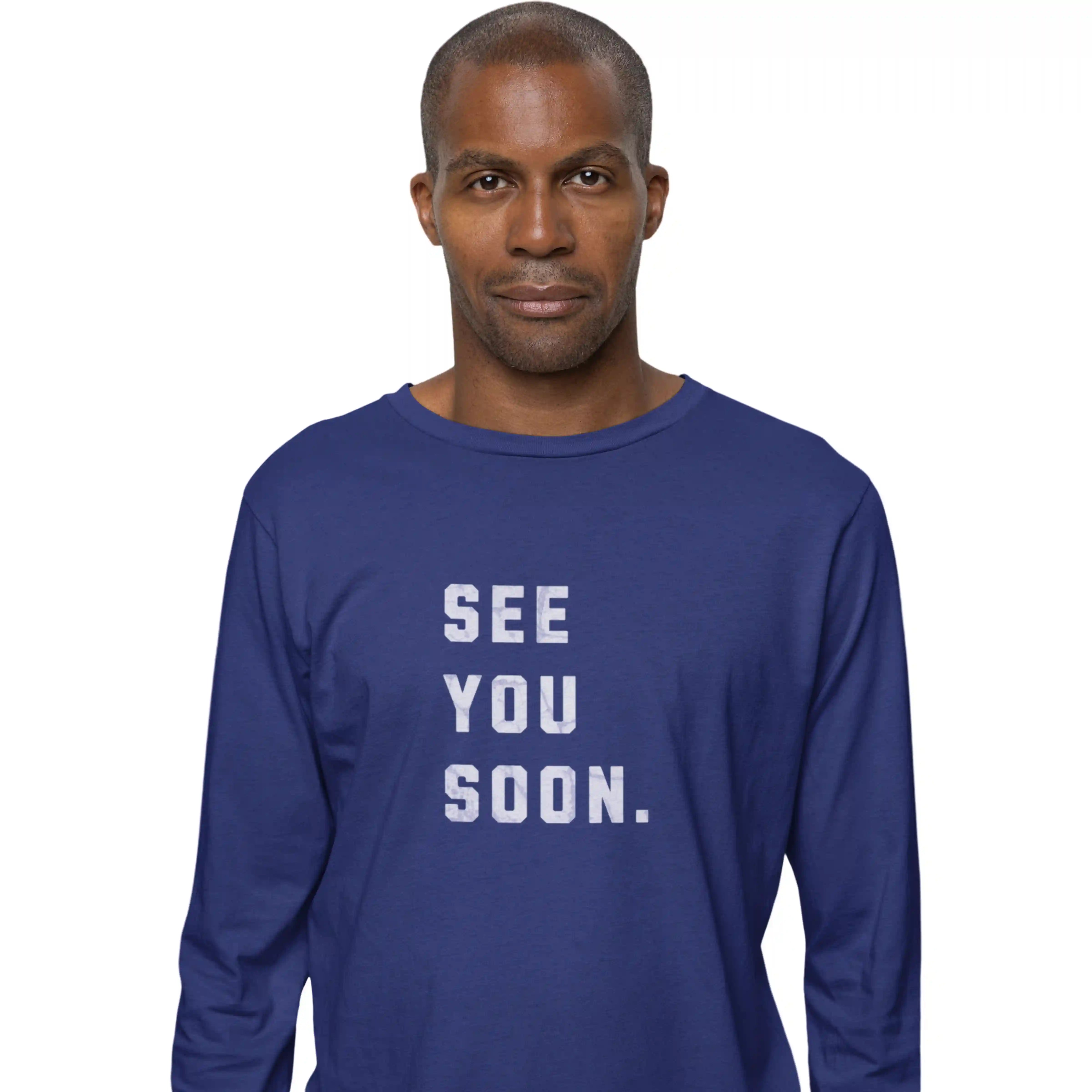 Man wearing a blue long-sleeve shirt with 'SEE YOU SOON.' text on a white background