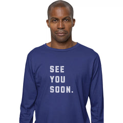 Man wearing a blue long-sleeve shirt with 'SEE YOU SOON.' text on a white background