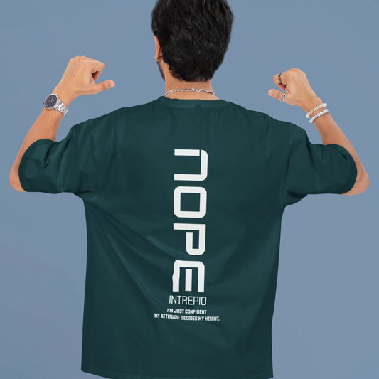 Person wearing a green t-shirt with 'NOPE' printed on the back against a blue background