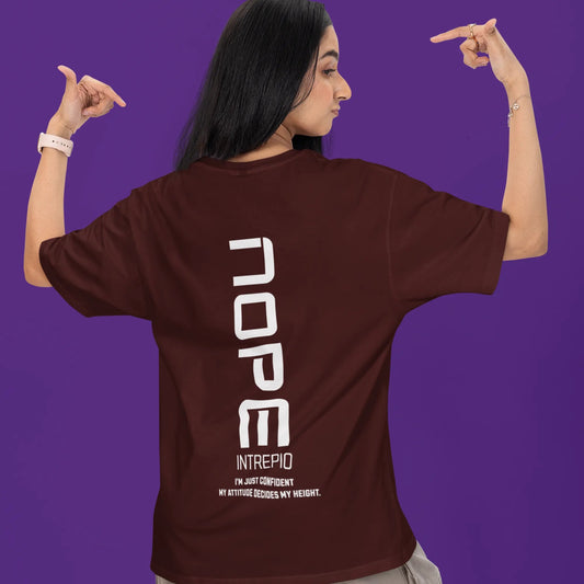 Person wearing a brown t-shirt with 'NOPE' printed on the back against a purple background