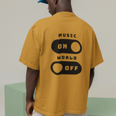 Person wearing a mustard yellow t-shirt with 'Music On World Off' text on the back, standing against a plain background.