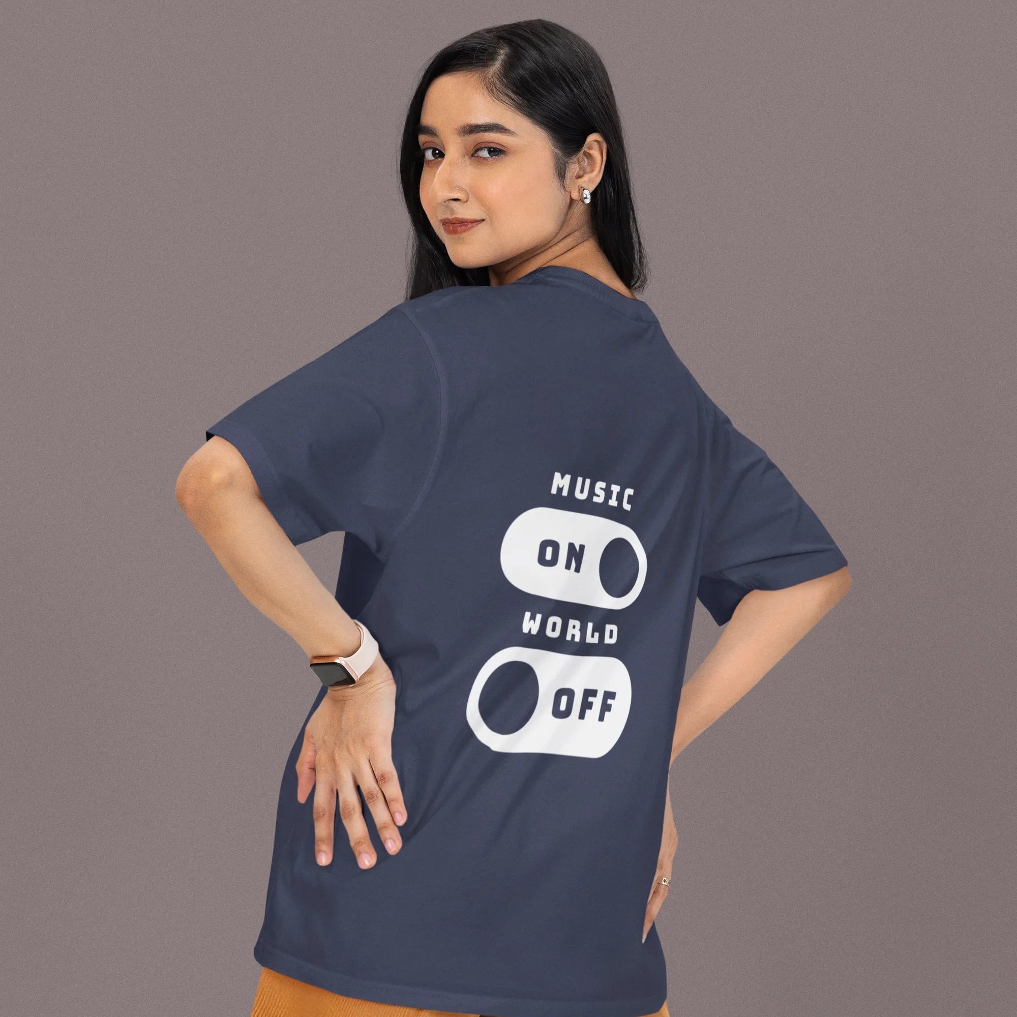 Person wearing a navy blue t-shirt with 'Music On World Off' text on the back, standing against a plain background.