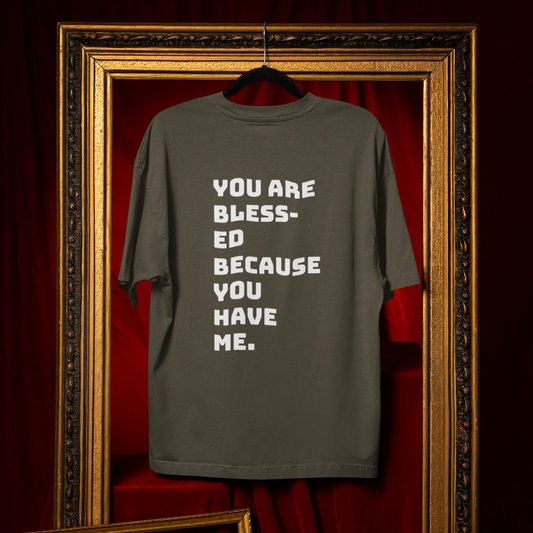 Gray t-shirt with motivational text on a red curtain background