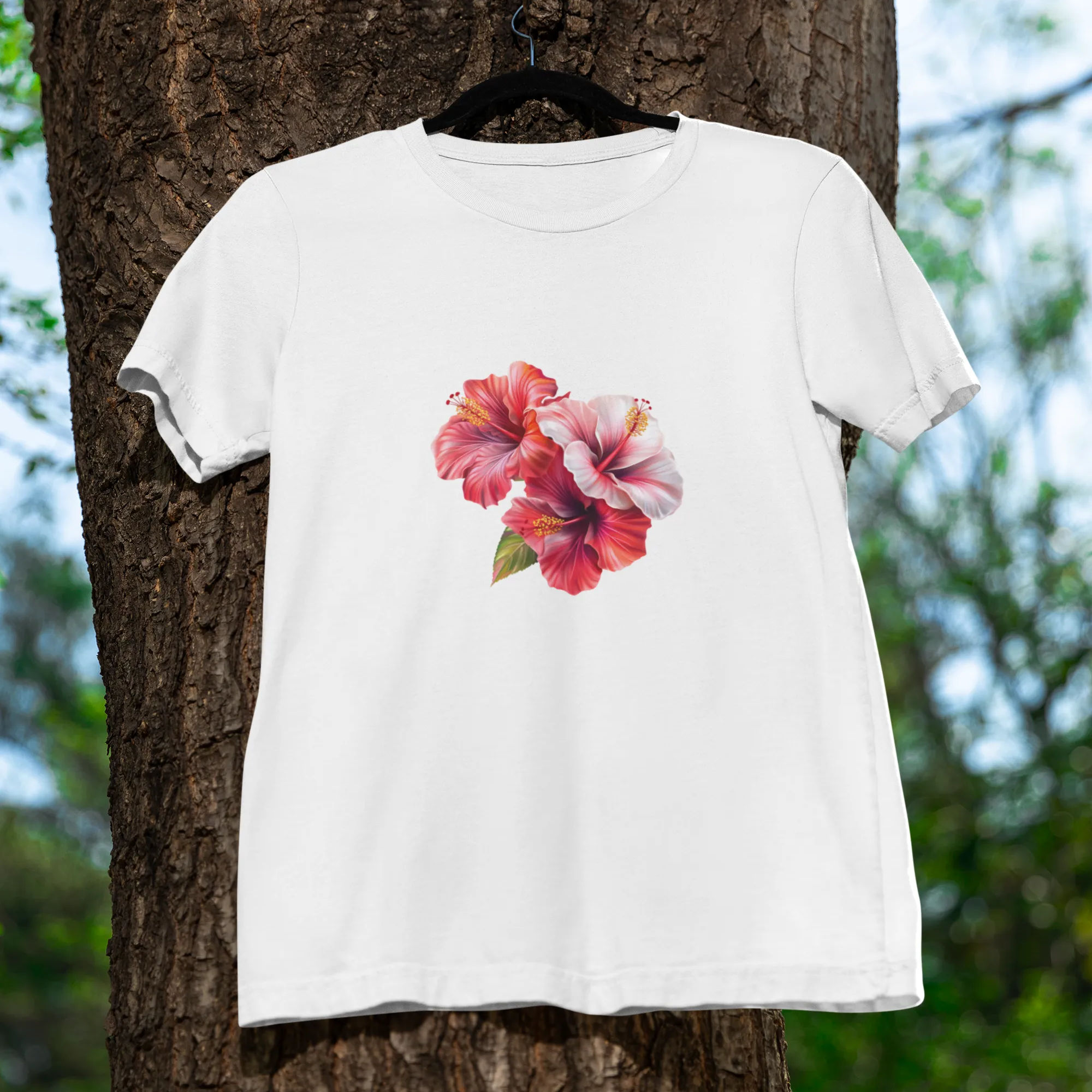 White t-shirt with a floral design hanging on a tree