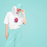 Person wearing a white t-shirt with a colorful flower design on a light blue background