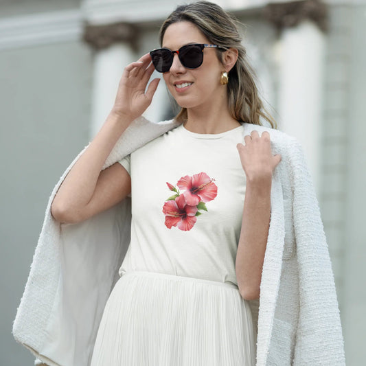 Woman wearing a white dress with a floral design and sunglasses, standing outdoors.