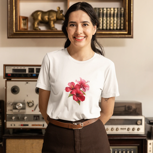 Woman wearing a white t-shirt with a floral design in a room with vintage equipment.