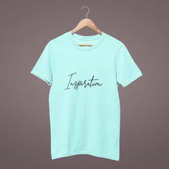 Mint green t-shirt with 'Inspiration' text on a hanger against a dark background