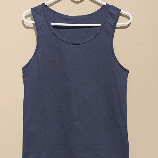 Navy blue tank top on a white hanger against a beige background
