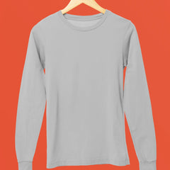 Gray long-sleeve shirt on a hanger against an orange background