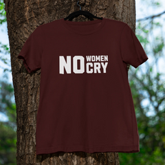 Brown t-shirt with 'NO WOMEN CRY' text hanging on a tree