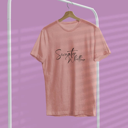 Pink t-shirt with 'Sweater Weather' text on a hanger against a purple background