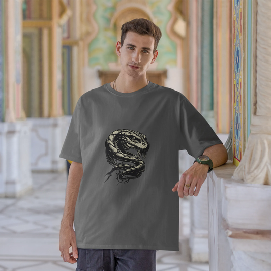 Man wearing a gray t-shirt with a snake design in an ornate architectural setting