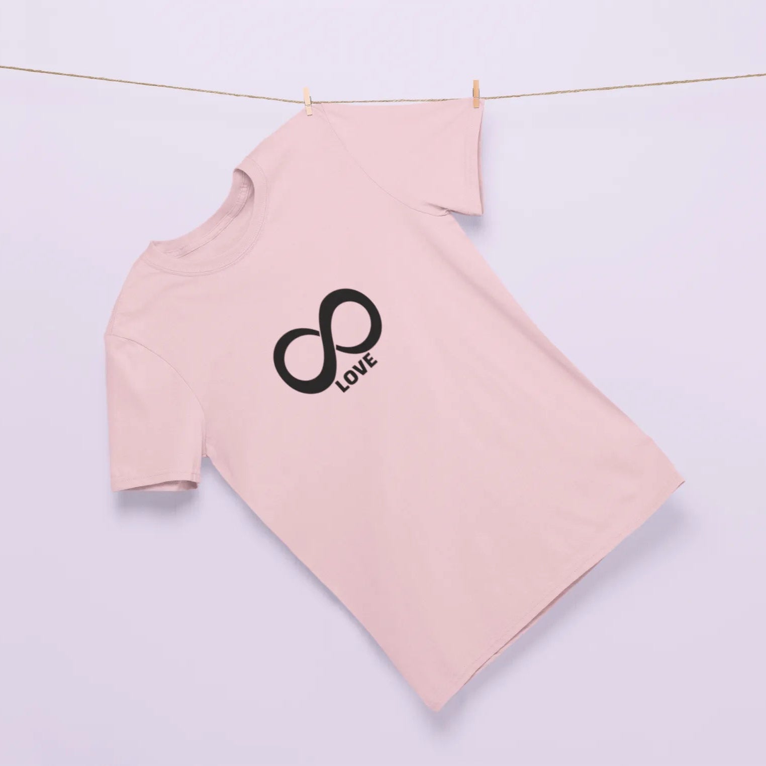 Pink long-sleeve shirt with a black infinity symbol and 'Love' text on a light purple background