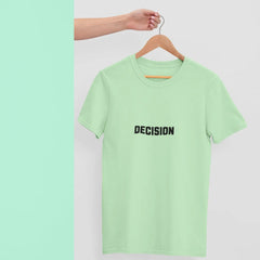 Light green t-shirt with 'DECISION' text on a hanger against a light gray background