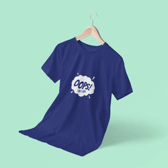 Blue t-shirt with a graphic design on a hanger against a light green background