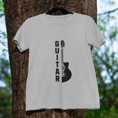 White t-shirt with guitar graphic and 'GUITAR' text on a tree trunk