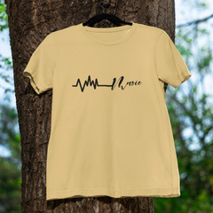 Beige t-shirt with a black design hanging on a tree