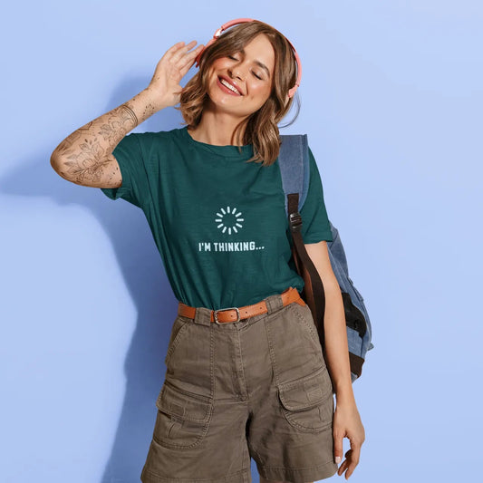 Woman wearing a green t-shirt with text, standing against a light blue background